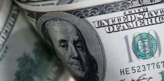Dollar holds gains after Fed expresses virus concerns