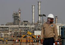 An employee looks on at Saudi Aramco oil facility in Abqaiq, Saudi Arabia