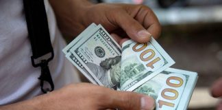 A man counts U.S. dollars in Tehran, Iran July 7, 2019. Nazanin Tabatabaee/ WANA