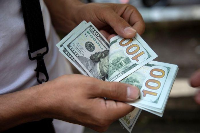 A man counts U.S. dollars in Tehran, Iran July 7, 2019. Nazanin Tabatabaee/ WANA