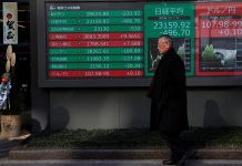 A decoration for celebrating new year is seen next to a stock index board outside a brokerage in Tokyo, Japan, January 6, 2020