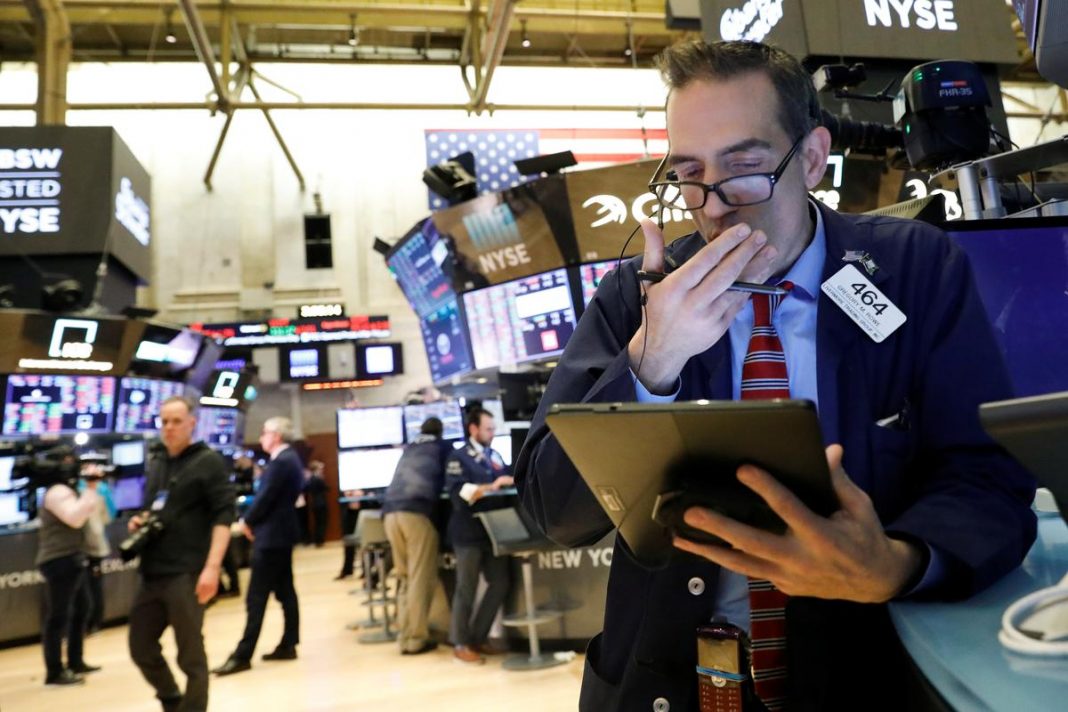 Traders work on the floor at the New York Stock Exchange (NYSE) in New York, U.S., February 27, 2020.