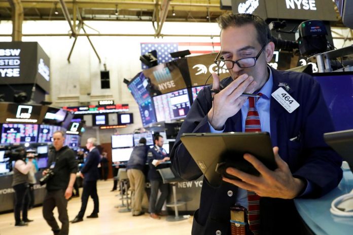 Traders work on the floor at the New York Stock Exchange (NYSE) in New York, U.S., February 27, 2020.