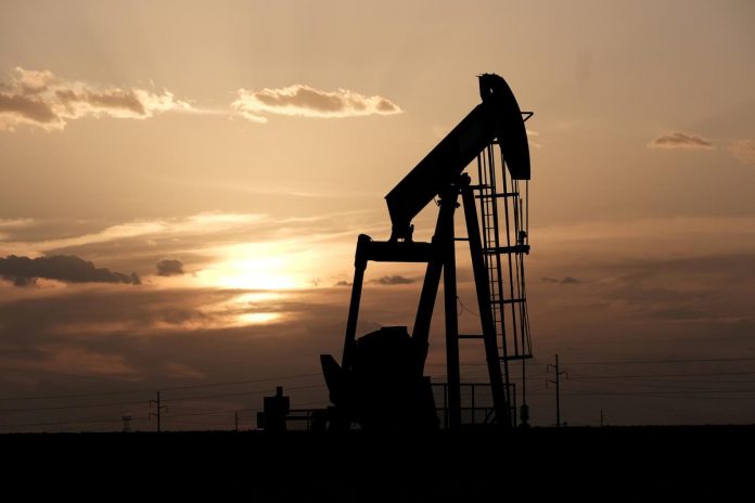 Oil pump jacks work at sunset near Midland, Texas, U.S., August 21, 2019.