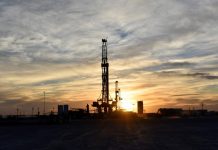 Drilling rigs operate at sunset in Midland, Texas, U.S.
