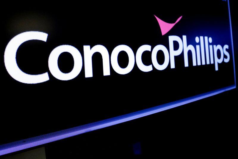 The logo for ConocoPhillips is displayed on a screen on the floor at the New York Stock Exchange