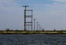 Electric power lines run through the "Uppards," part of Tangier Island, Virginia, U.S.