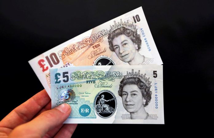 Sample polymer five and ten pound banknotes displayed at the Bank of England in London, Britain, September 10, 2013.