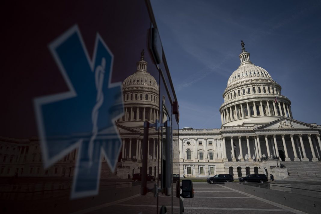 An ambulance sits parked on the plaza outside the U.S. Capitol