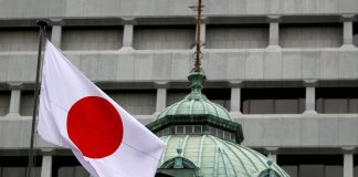 A Japanese flag flutters atop the Bank of Japan building in Tokyo, Japan, September 21, 2016.
