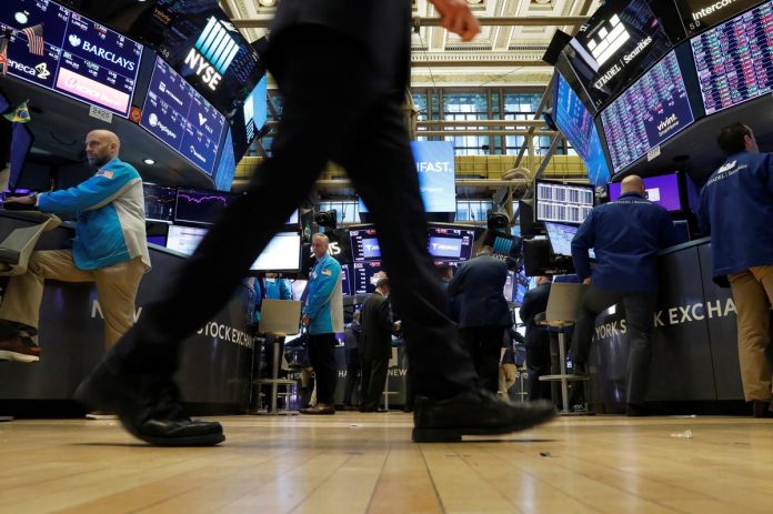 Traders work on the floor at the New York Stock Exchange (NYSE) in New York, U.S., March 2, 2020.