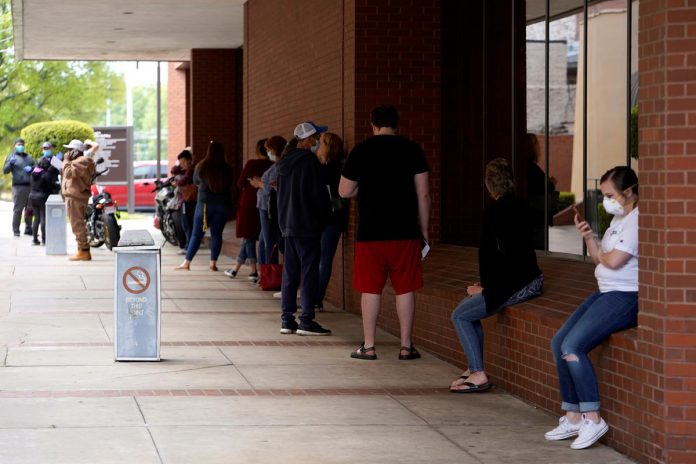 People who lost their jobs wait in line to file for unemployment following an outbreak of the coronavirus disease (COVID-19), at an Arkansas Workforce Center in Fort Smith, Arkansas, U.S
