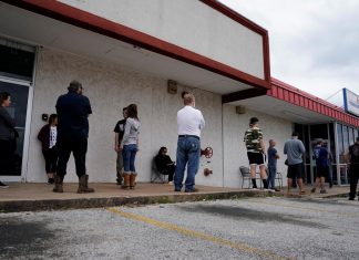 People who lost their jobs wait in line to file for unemployment following an outbreak of the coronavirus disease (COVID-19), at an Arkansas Workforce Center in Fayetteville, Arkansas, U.S.