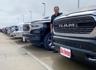 Jerry Bill, general manager of Stew Hansen Chrysler Dodge Jeep Ram, poses among a line of Ram trucks that he fears will be in very short supply by June if consumer demand remains strong, in Urbandale, Iowa, U.S.