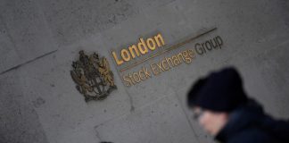 People walk past the London Stock Exchange Group offices in the City of London, Britain