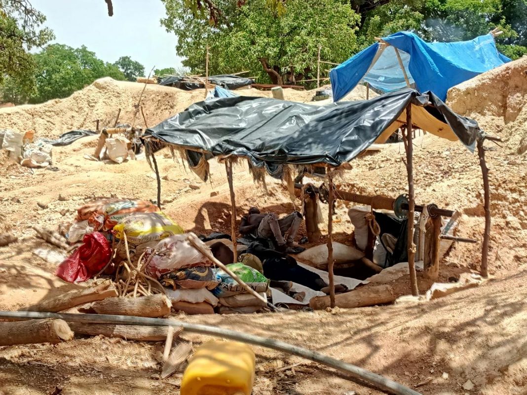 Informal gold miners are seen taking a break from work under the midday sun at an artisanal mining site near Dano, southern Burkina Faso