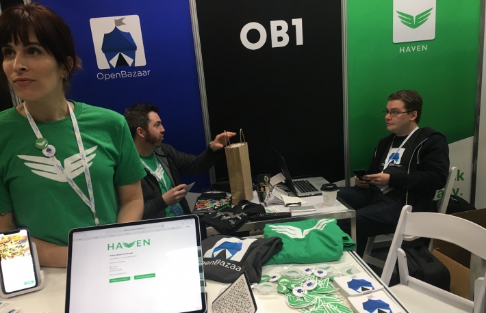 OB1 staff show off OpenBazaar at a 2019 conference.