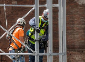 Construction workers assemble a scaffold at a job site, as phase one of reopening after lockdown begins, during the outbreak of the coronavirus disease (COVID-19) in New York City, New York, U.S.