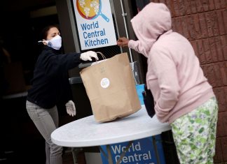 New Jersey First Lady Tammy Murphy hands out bags containing meals, face masks and other personal protective supplies to residents in need outside the NAN Newark Tech World during the outbreak of the coronavirus disease (COVID-19) in Newark, New Jersey