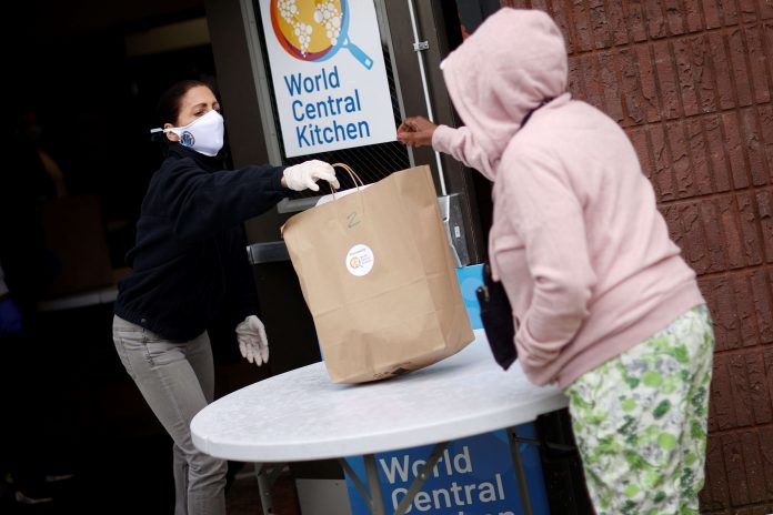 New Jersey First Lady Tammy Murphy hands out bags containing meals, face masks and other personal protective supplies to residents in need outside the NAN Newark Tech World during the outbreak of the coronavirus disease (COVID-19) in Newark, New Jersey