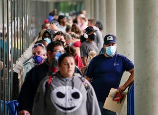 Hundreds of people line up outside a Kentucky Career Center hoping to find assistance with their unemployment claim in Frankfort, Kentucky, U.S. June