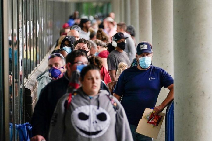 Hundreds of people line up outside a Kentucky Career Center hoping to find assistance with their unemployment claim in Frankfort, Kentucky, U.S. June