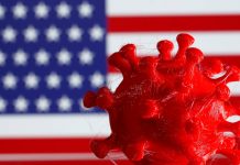 A 3D-printed coronavirus model is seen in front of a U.S. flag on display in this illustration taken March