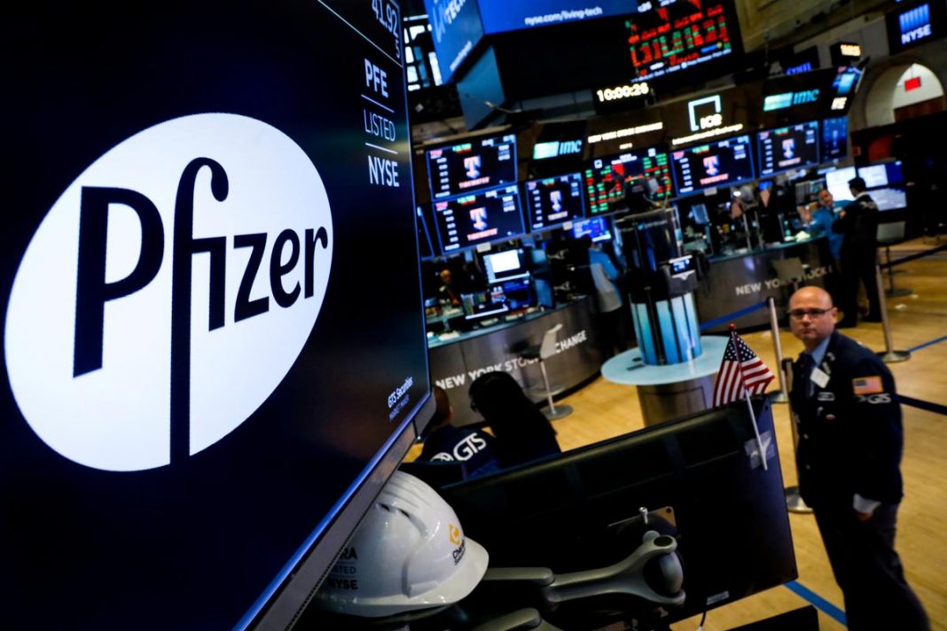 A logo for Pfizer is displayed on a monitor on the floor at the New York Stock Exchange (NYSE) in New York, U.S., July